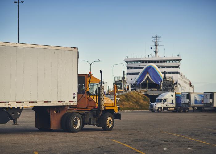 Truck driving onto ferry ramp