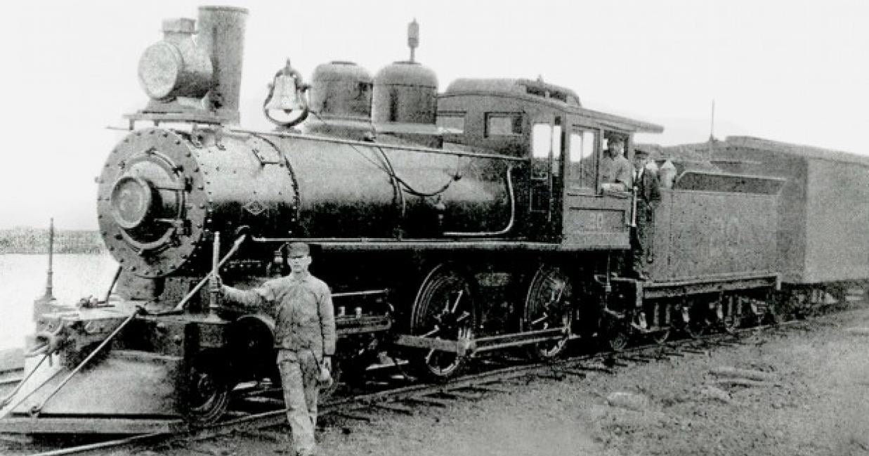 A man standing next to a train engine