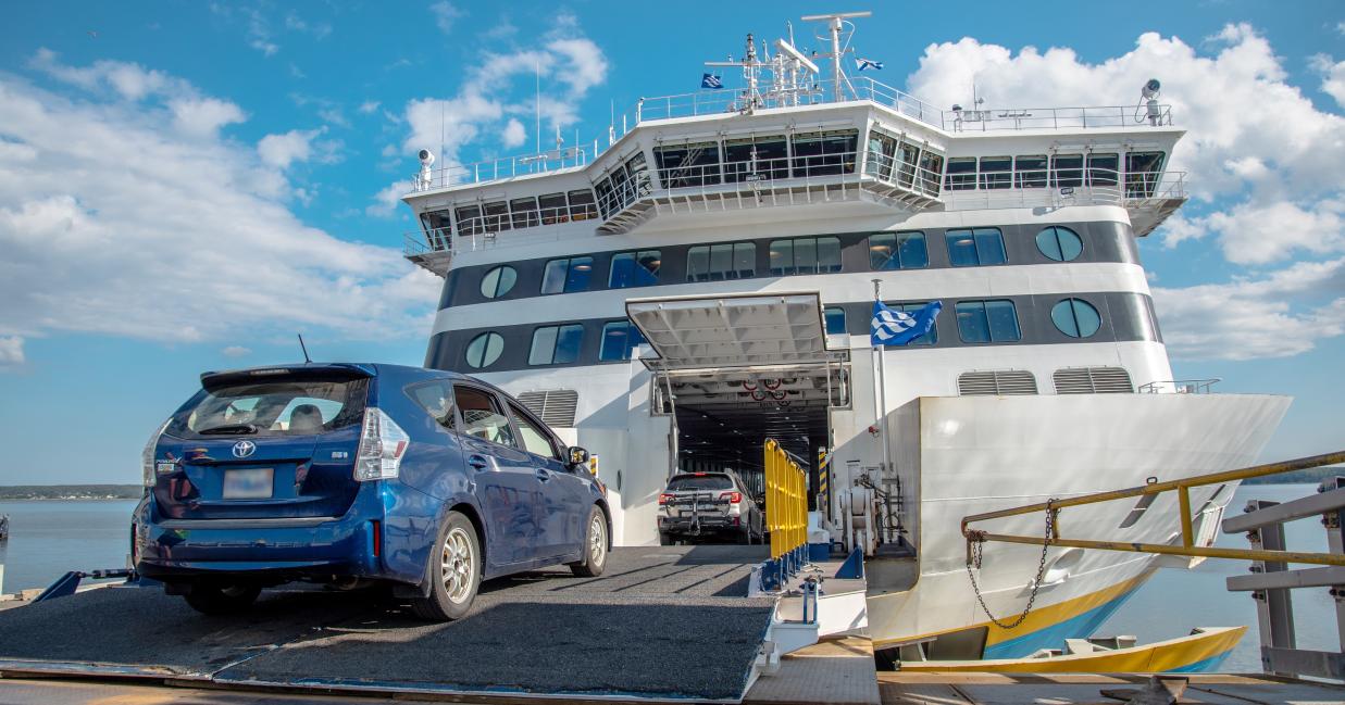 Blue prius drives onto the vessel