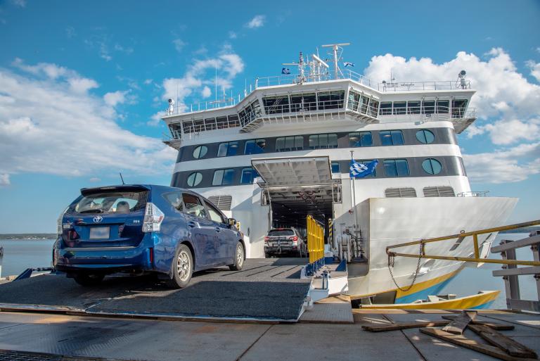 Blue prius drives onto the vessel